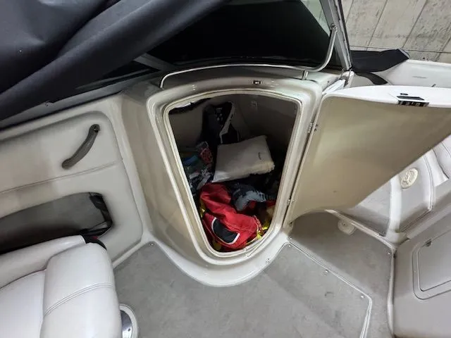 Slide: The Image of Storage compartment in 2001 Crownline 230 boat filled with gear. - 9