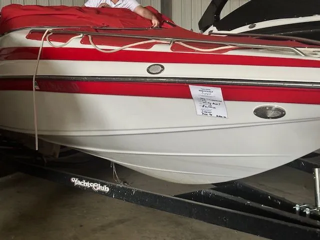 The Image of 2006 Crownline 266 boat with red cover on trailer. - 1