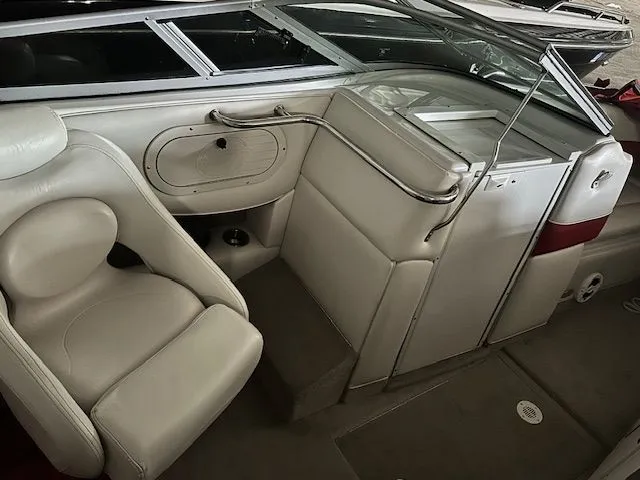 Slide: The Image of Interior of a 2006 Crownline 266 boat with white leather seats. - 11