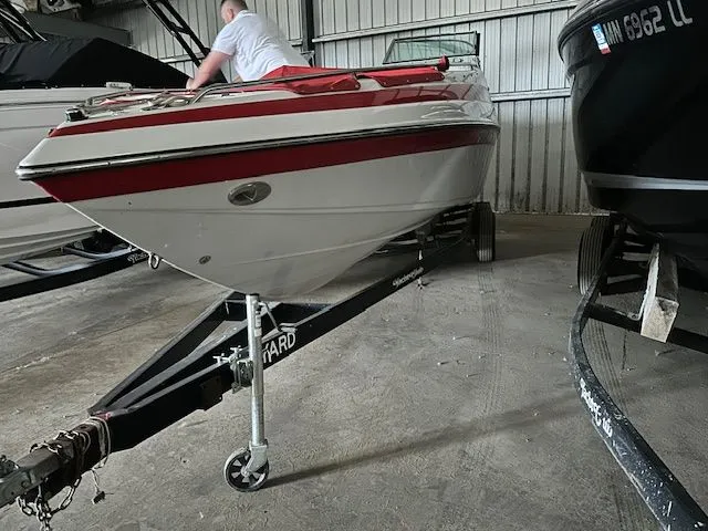 Slide: The Image of 2006 Crownline 266 boat on trailer in storage facility. - 15