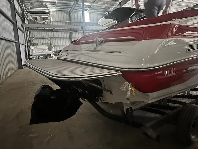 Slide: The Image of Red and white 2006 Crownline 266 boat in a storage facility. - 3