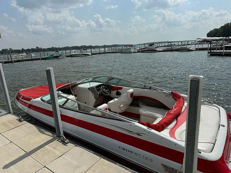 Slide: The Image of 2006 Crownline 266 boat docked on a sunny day. - 4