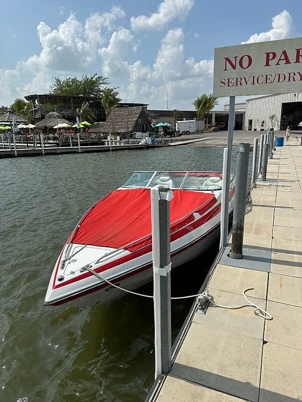 Slide: The Image of 2006 Crownline 266 boat docked with red cover. - 6