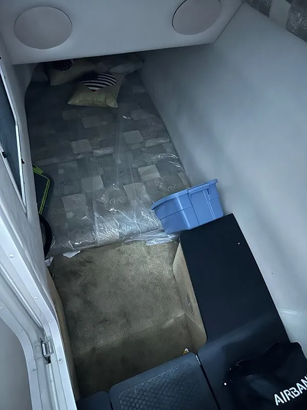 Slide: The Image of Interior of a 2005 Crownline 316 LS with bed and storage. - 11