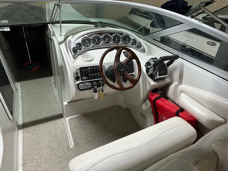Slide: The Image of Interior of a 2005 Crownline 316 LS boat with wooden steering wheel. - 3