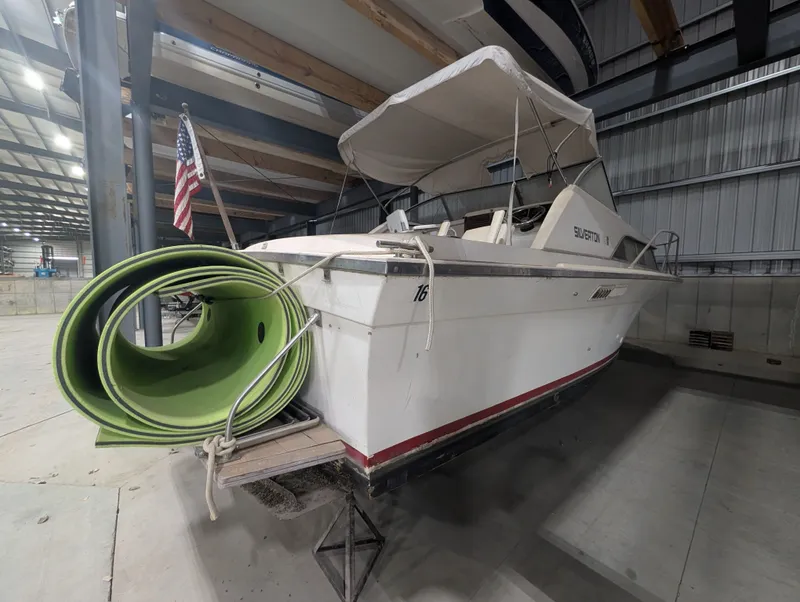 Slide: The Image of 1976 Silverton 26' boat in warehouse with green slide. - 4