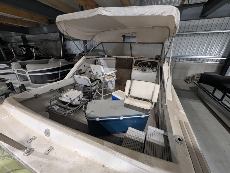 Slide: The Image of 1976 Silverton 26' boat in warehouse with seating area. - 5