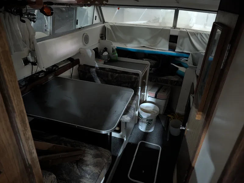 Slide: The Image of Interior of a 1976 Silverton 26' boat with table and seating area. - 7