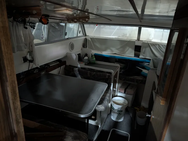 Slide: The Image of Interior of a 1976 Silverton 26' boat with table and seating area. - 8