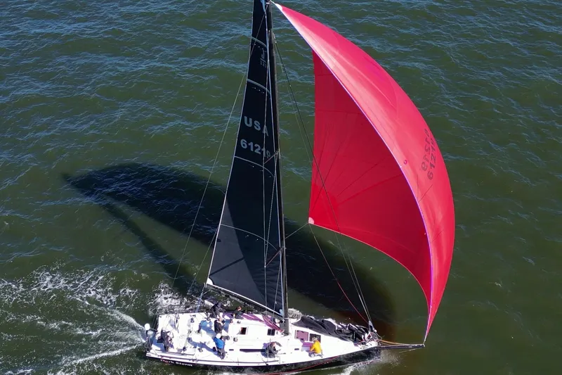 Slide: The Image of 2019 J Boats J 121 sailing with vibrant red spinnaker on open water. - 11