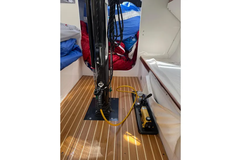 Slide: The Image of Interior of 2019 J Boats J/121 sailboat with wooden flooring and sailing equipment. - 16