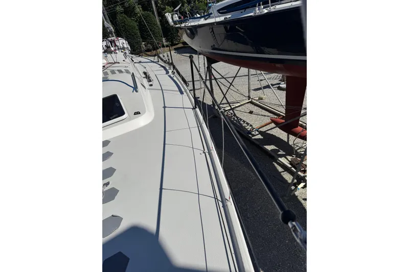 Slide: The Image of 2019 J Boats J/121 sailboat on dry dock, showcasing deck and railing details. - 23