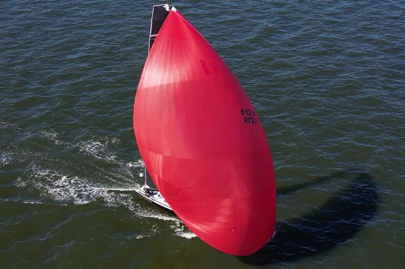 Slide: The Image of 2019 J Boats J 121 sailing with a large red spinnaker on open water. - 9