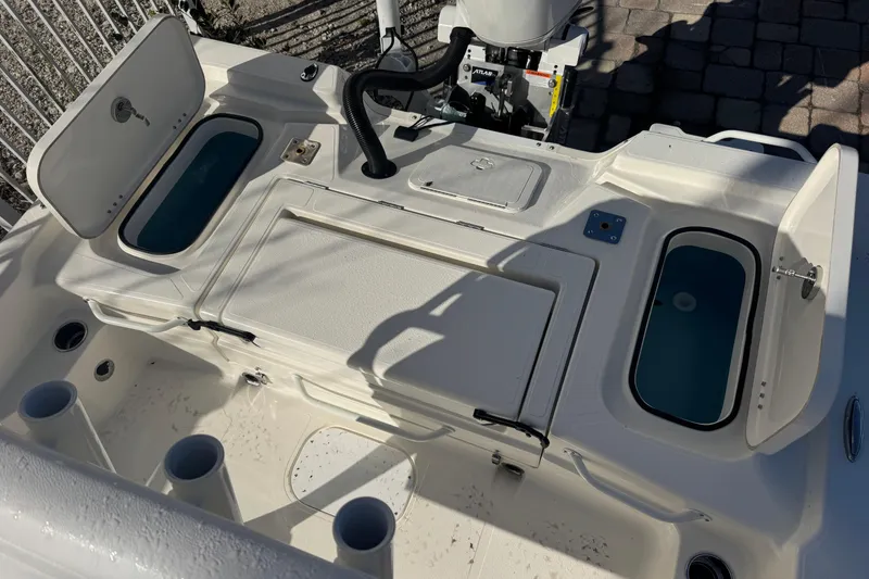 Slide: The Image of 2026 Skeeter SX221 boat deck with storage compartments and rod holders. - 13