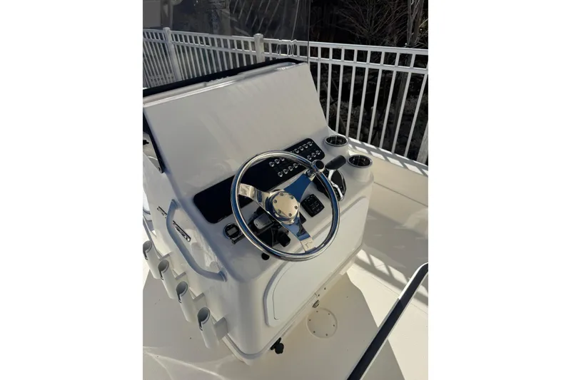 Slide: The Image of 2026 Skeeter SX221 boat console with steering wheel and controls. - 14
