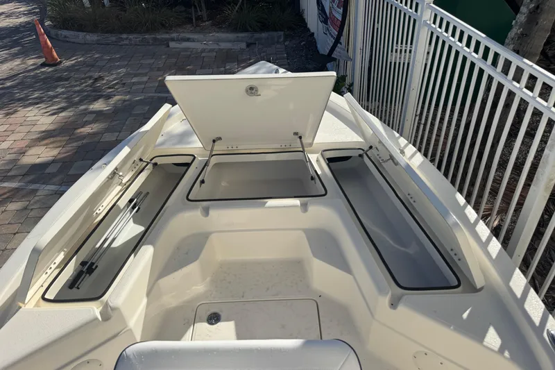 Slide: The Image of Open storage compartments on a 2026 Skeeter SX221 boat, showcasing ample space and design. - 19