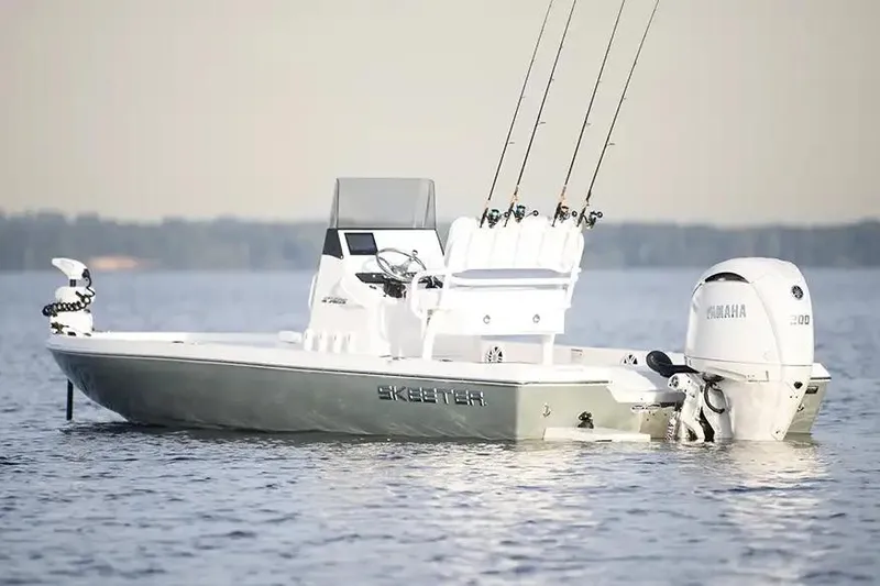 Slide: The Image of Manufacturer Provided Image: 2026 Skeeter SX221 fishing boat on calm water with Yamaha outboard motor. - 2