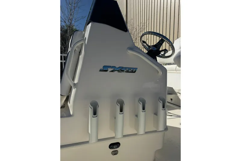 Slide: The Image of 2026 Skeeter SX221 boat console with rod holders and steering wheel. - 24