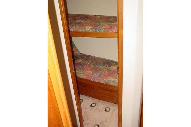 Slide: The Image of Engine room of a 1996 Viking 50 Convertible yacht, showcasing dual engines and equipment. - 16