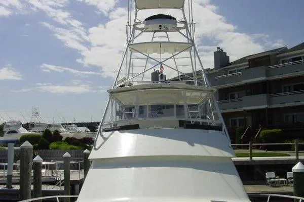 Slide: The Image of 1996 Viking 50 Convertible yacht illuminated with blue lights at night. - 2