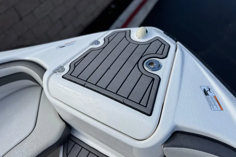 Slide: The Image of 2018 Yamaha AR240 boat deck with non-slip surface and safety warning labels. - 12