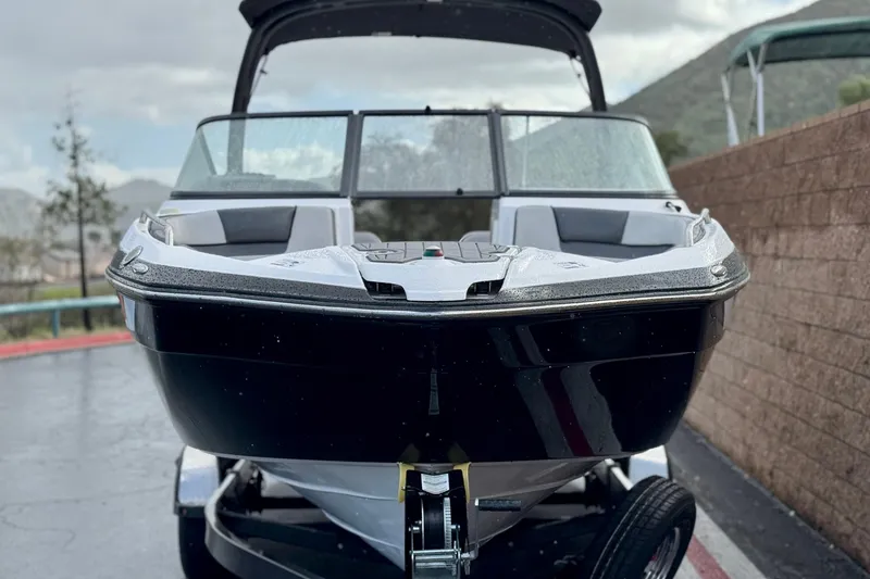 Slide: The Image of 2018 Yamaha Boats AR240 on trailer, sleek black design, parked outdoors. - 2