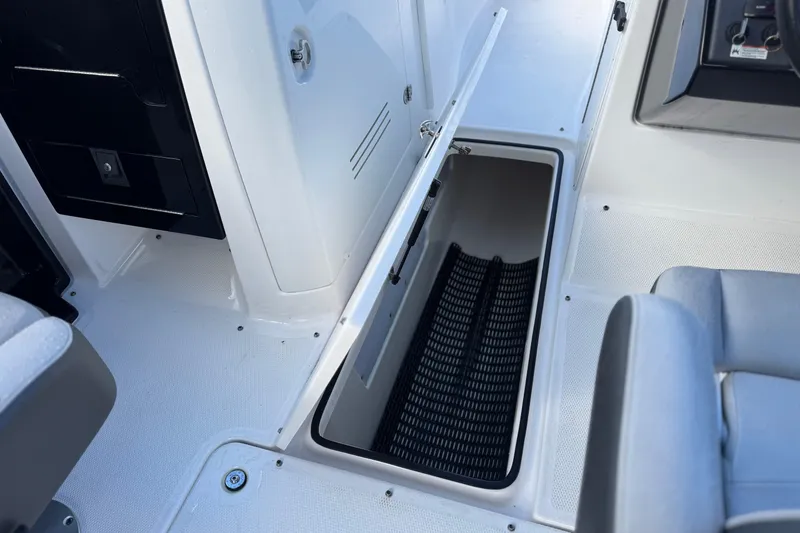 Slide: The Image of 2018 Yamaha AR240 boat interior with open storage compartment and seating. - 23
