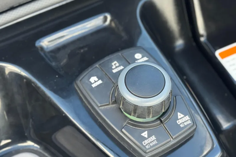 Slide: The Image of Control panel of a 2018 Yamaha Boats AR240, featuring cruise and audio buttons. - 27
