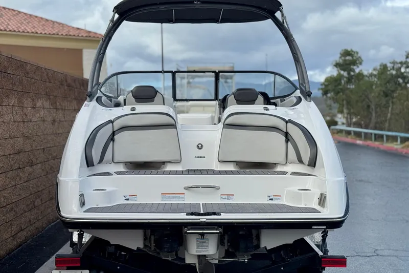 Slide: The Image of 2018 Yamaha Boats AR240, rear view, showcasing sleek design and spacious seating. - 4