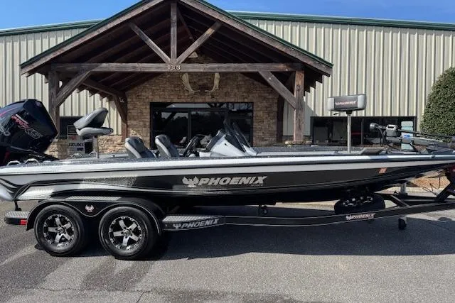 The Image of 2022 Phoenix 721 ProXP boat parked outside a building with wooden accents. - 1
