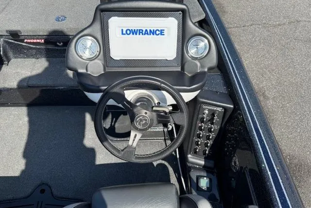 Slide: The Image of 2022 Phoenix 721 ProXP boat dashboard with Lowrance display and steering wheel. - 12