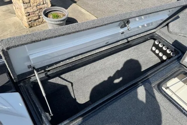 Slide: The Image of Open storage compartment of 2022 Phoenix 721 ProXP boat, showing interior details. - 16