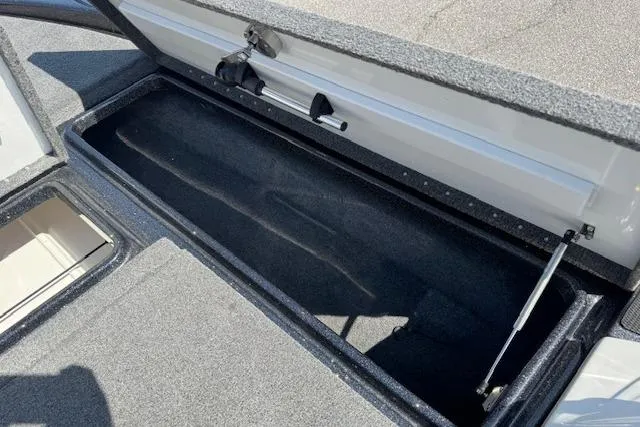 Slide: The Image of Open storage compartment in a 2022 Phoenix 721 ProXP boat, showcasing spacious interior. - 17