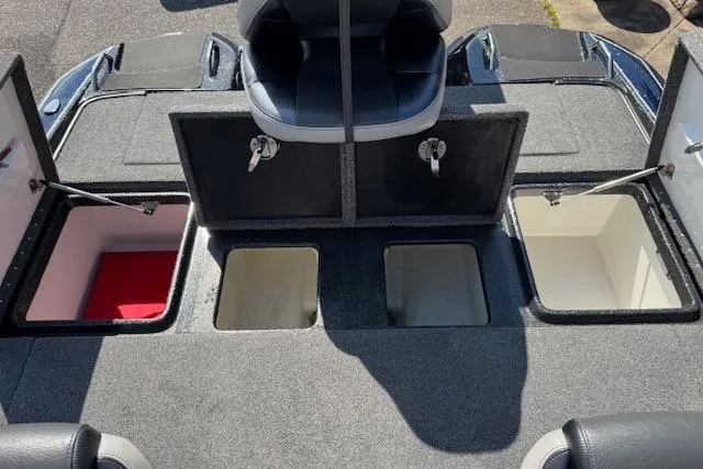 Slide: The Image of 2022 Phoenix 721 ProXP boat storage compartments with open lids and seating. - 21
