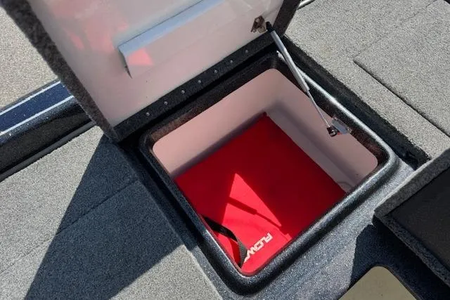 Slide: The Image of Open storage compartment in 2022 Phoenix 721 ProXP boat, featuring red interior. - 22