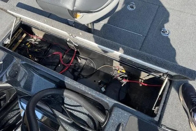Slide: The Image of 2022 Phoenix 721 ProXP boat interior showing open storage compartment with wiring. - 24