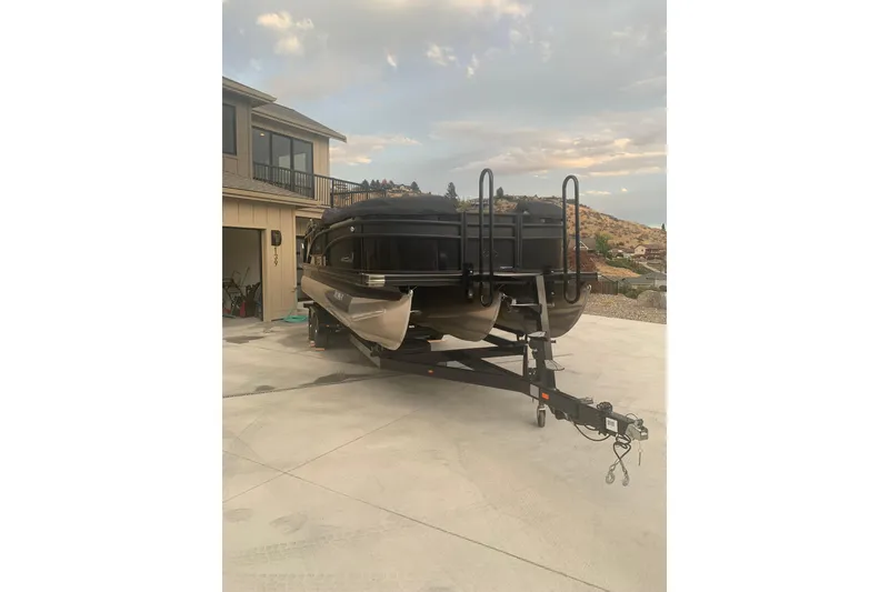 Slide: The Image of 2022 Barletta Corsa 25U pontoon boat on trailer in driveway. - 3