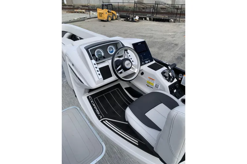 Slide: The Image of 2022 Barletta Corsa 25U boat cockpit with modern steering and dashboard controls. - 6