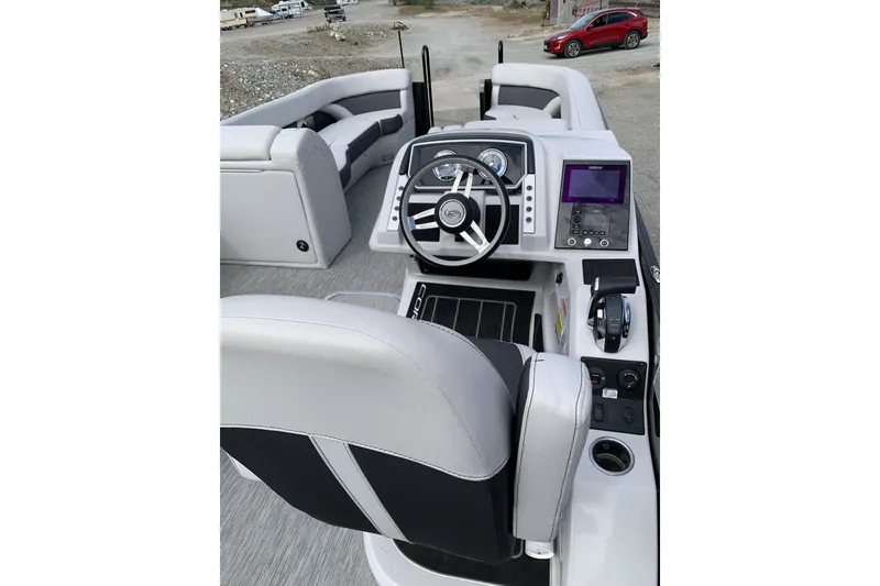 Slide: The Image of Interior view of 2022 Barletta Corsa 25U boat, featuring modern steering and control panel. - 7
