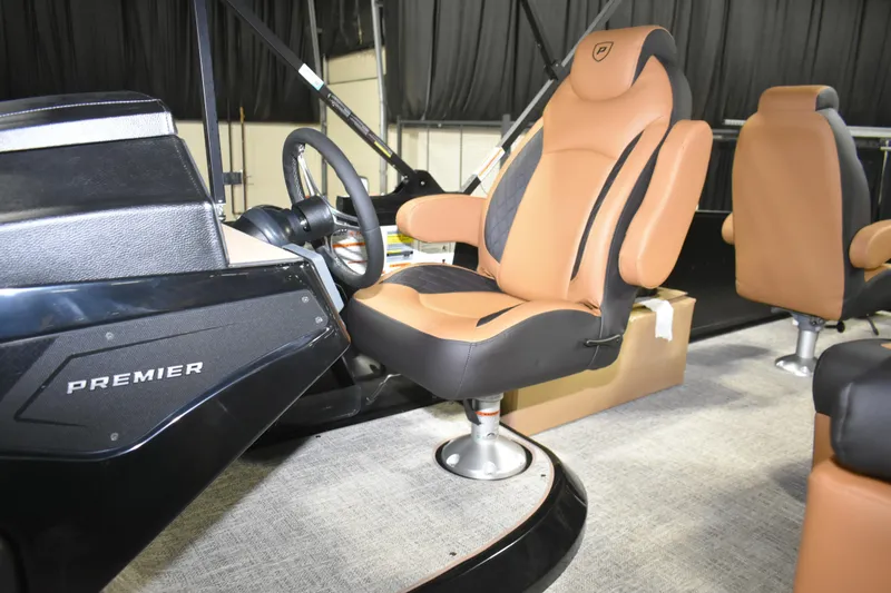Slide: The Image of 2026 Premier 230 Sunsation Angler 2pt boat interior with luxurious seating and steering console. - 13