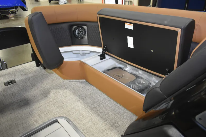 Slide: The Image of 2026 Premier 230 Sunsation Angler 2pt boat interior with storage compartment and speaker. - 21