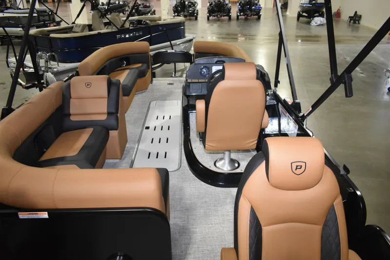 Slide: The Image of 2026 Premier 230 Sunsation Angler 2pt boat interior with tan and black seating. - 7