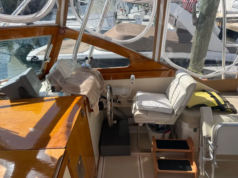 Slide: The Image of 1978 Dyer 29 Trunk Cabin boat interior with steering wheel and seating. - 11