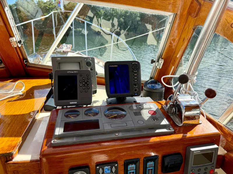 Slide: The Image of 1978 Dyer 29 Trunk Cabin helm with navigation instruments and controls. - 12