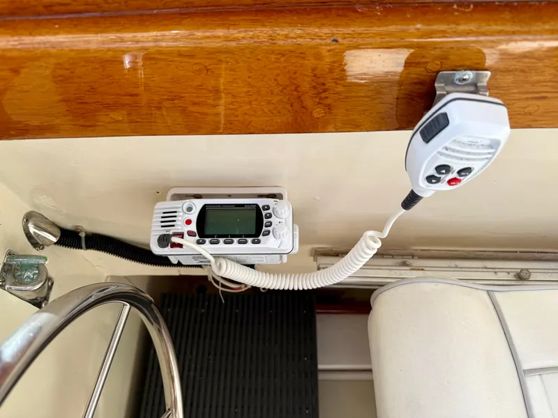 Slide: The Image of 1978 Dyer 29 Trunk Cabin boat interior with radio and microphone setup. - 14