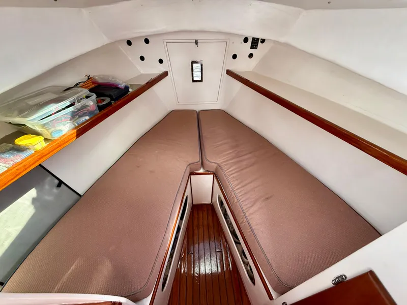 Slide: The Image of 1978 Dyer 29 Trunk Cabin interior with twin berths and wooden flooring. - 15