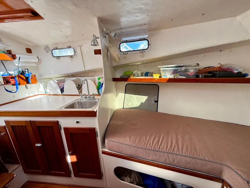 Slide: The Image of Interior of a 1978 Dyer 29 Trunk Cabin boat with kitchenette and seating area. - 17
