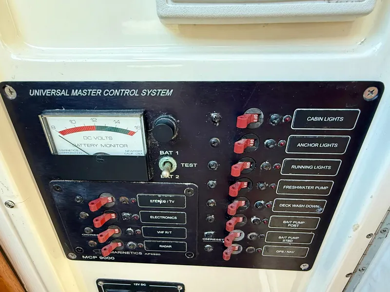 Slide: The Image of Control panel of a 1978 Dyer 29 Trunk Cabin boat with various switches and battery monitor. - 24