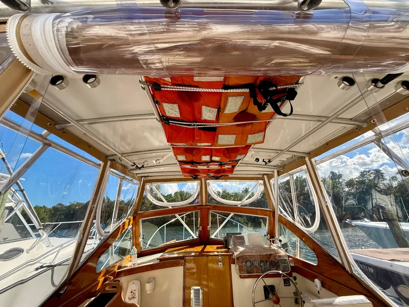 Slide: The Image of Interior view of a 1978 Dyer 29 Trunk Cabin boat with wooden accents and clear windows. - 7