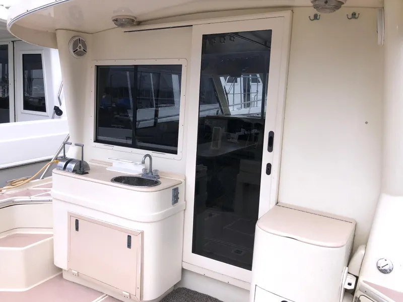 Slide: The Image of 2000 Albin 35 Tournament Express boat interior with sink and sliding door. - 11